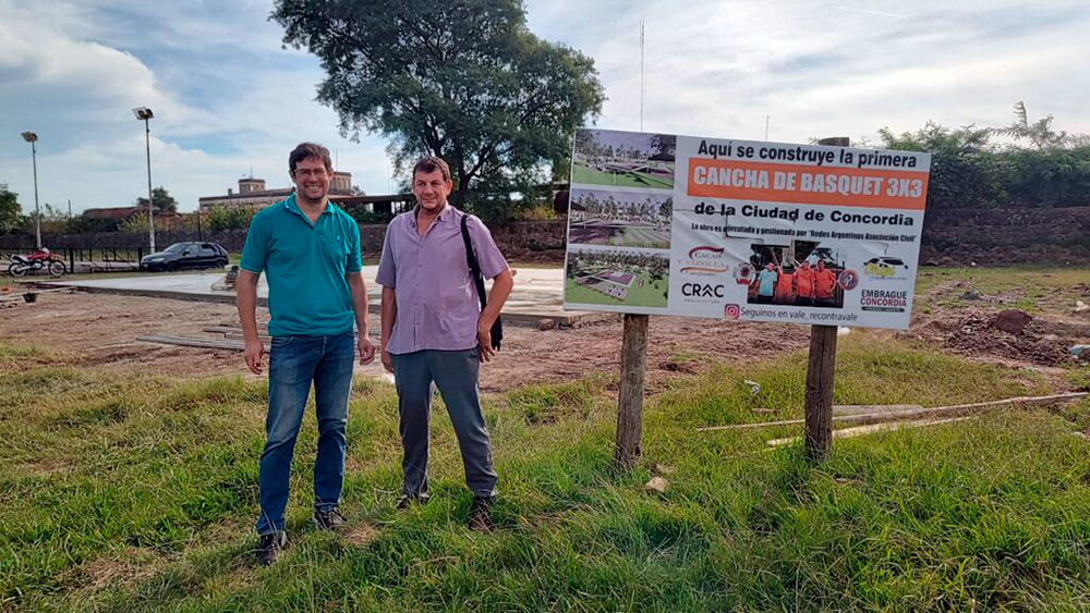 Larken y Jacobo junto a la cancha que va tomando forma.